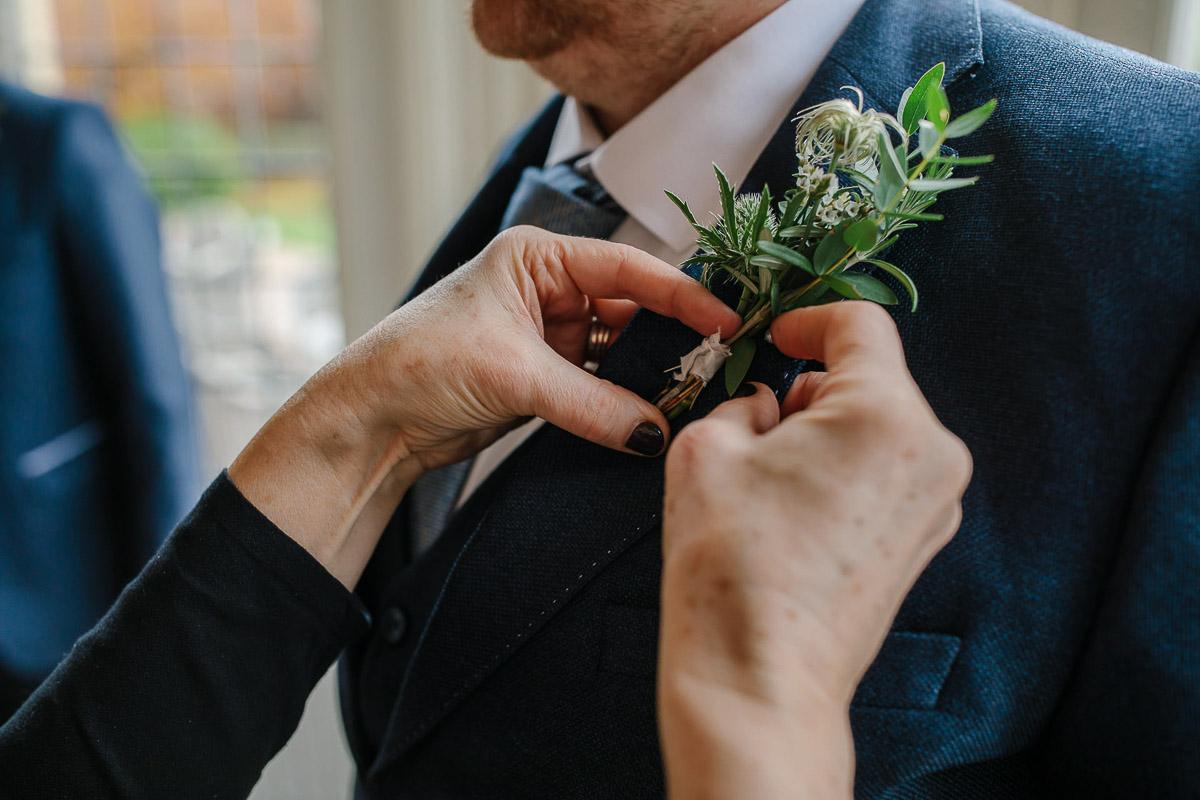 groom flowers button holes suits wedding falcon manor winter wedding