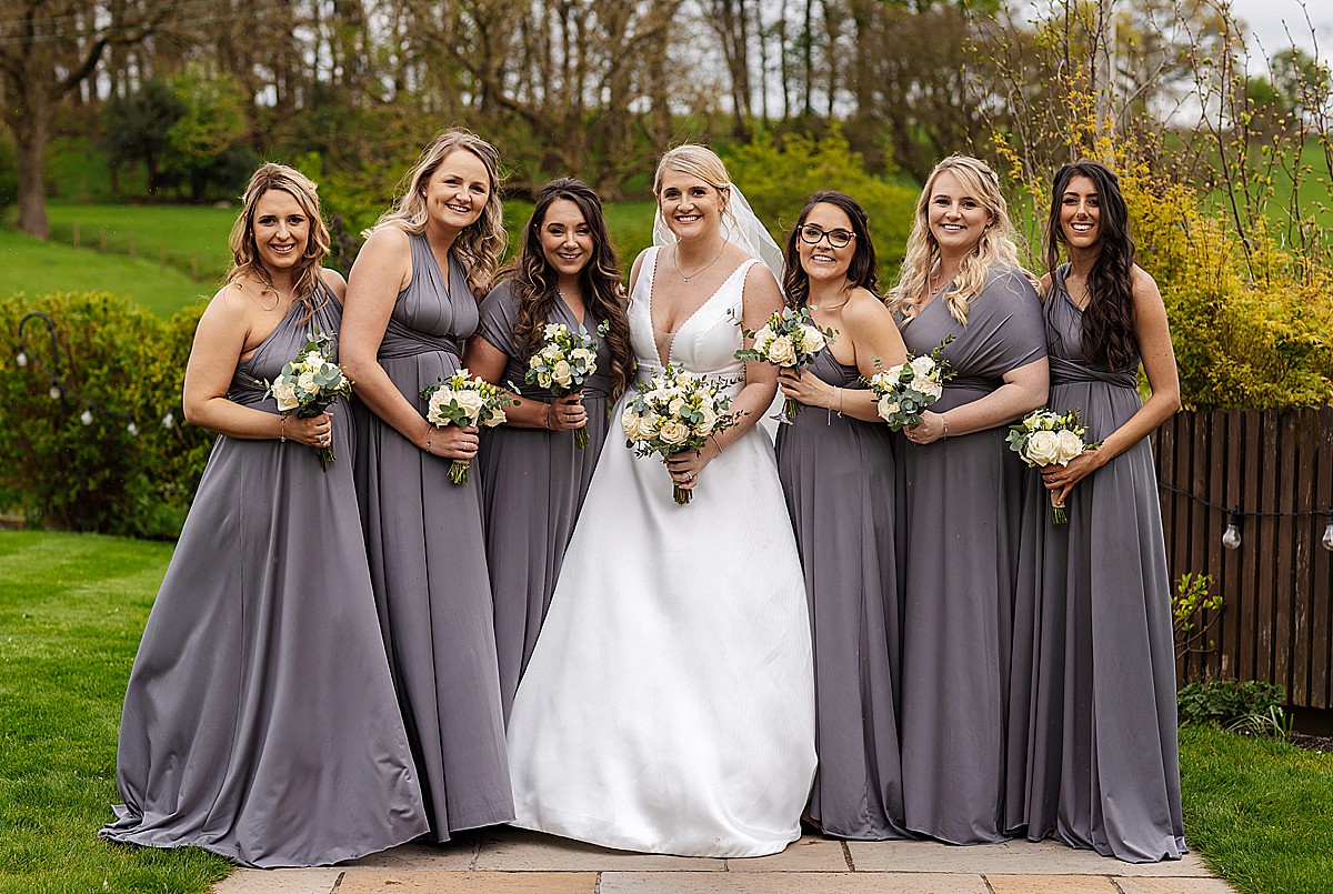 Brides maids portraits outside on the lawn at Stirk House Luxury hotel Wedding