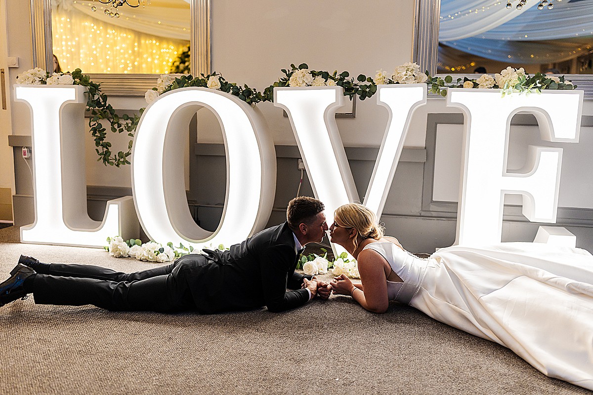 the Stirk house luxury wedding bride and groom kissing infant of love letters 