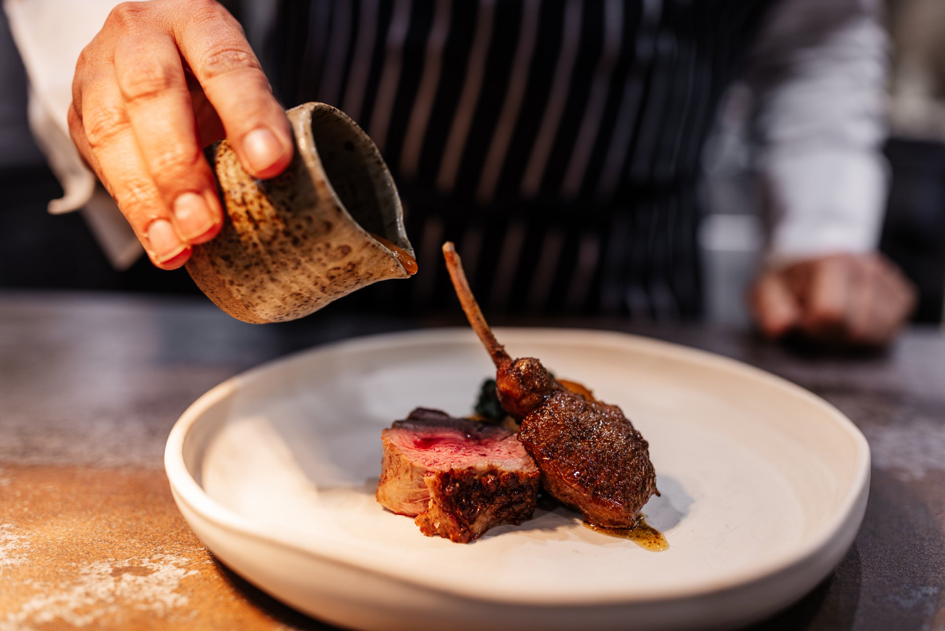 pouring sauce on dish Luxury Food Photography lancashire