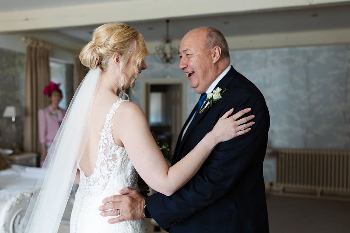 Brides Father seeing her for the first time in her wedding dress at Stanley House Wedding Photography Venue 