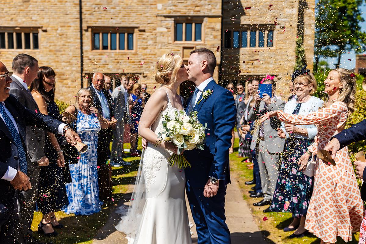 Confetti shot of couple kissing outside at Stanley House Wedding Photography Venue 