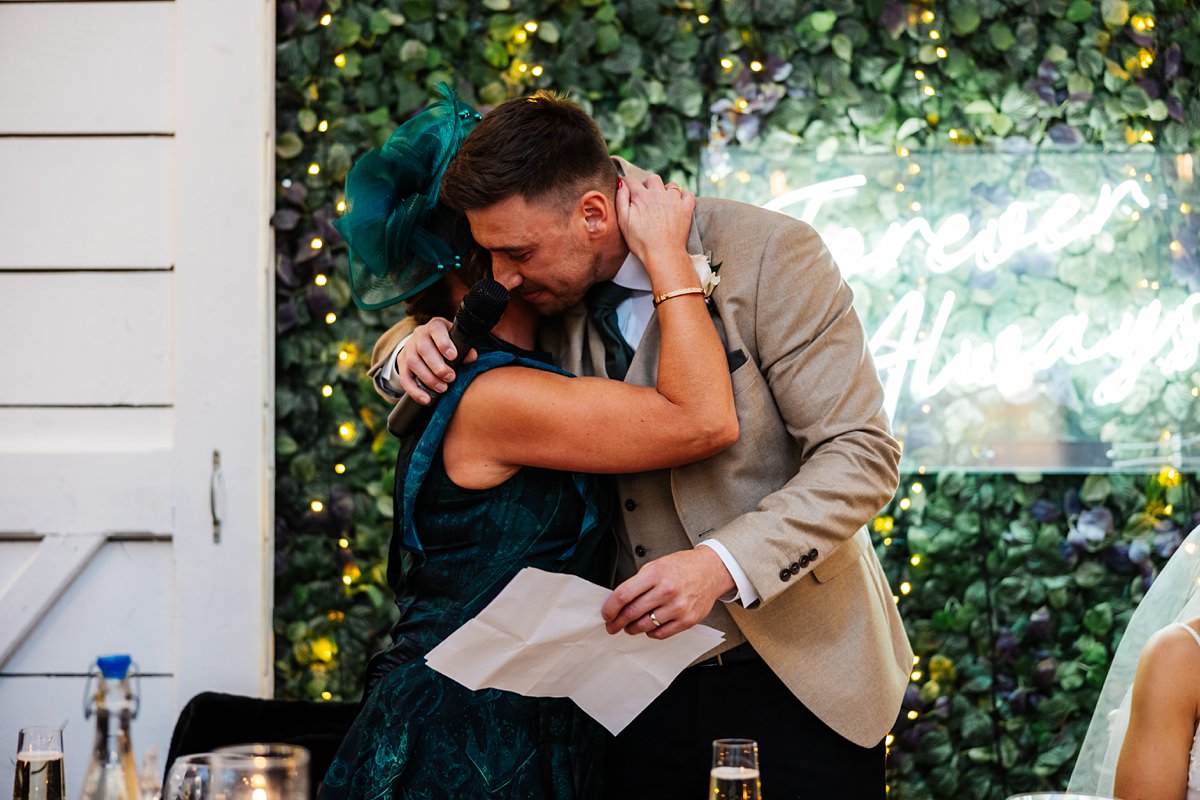 Bashall Barn Twilight Winter wedding Photography mum groom hugs 