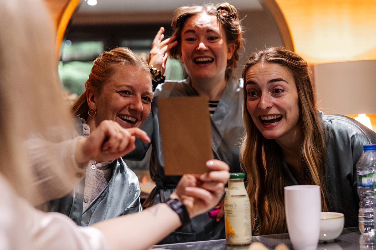 German friends laughing after reading beautiful note from the bride at Bartle Hall