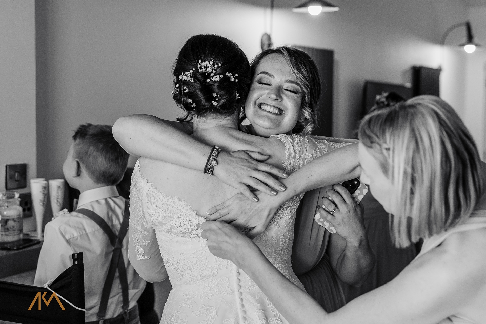 bridesmaid hug bride wedding dress